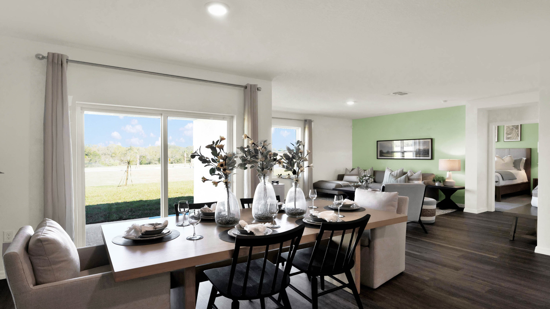 Dining room table with seating overseeing living area.