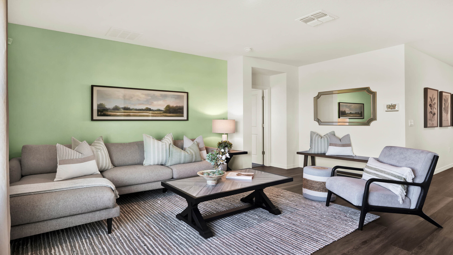 Living area with couch seating and natural lighting next to access to Master Bedroom.