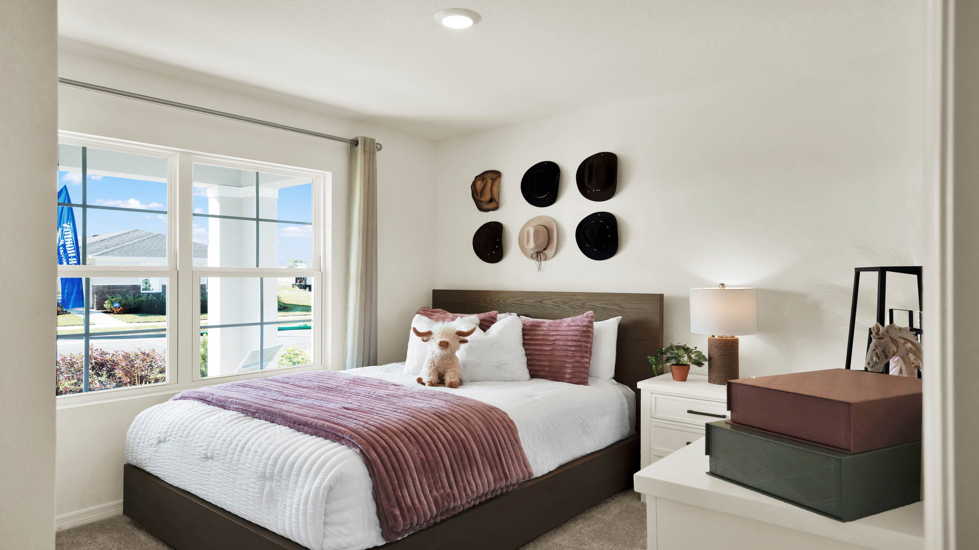 Guest bedroom with bed, nighstands and natural lighting.