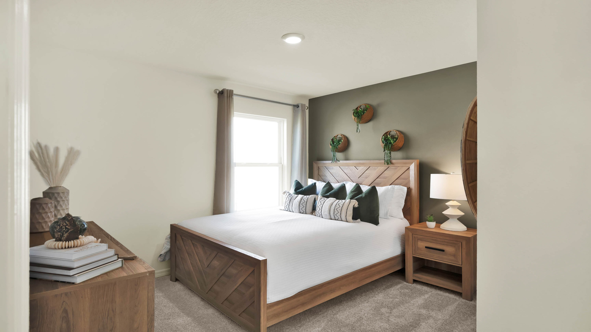 Guest bedroom with bed, nighstands and natural lighting.