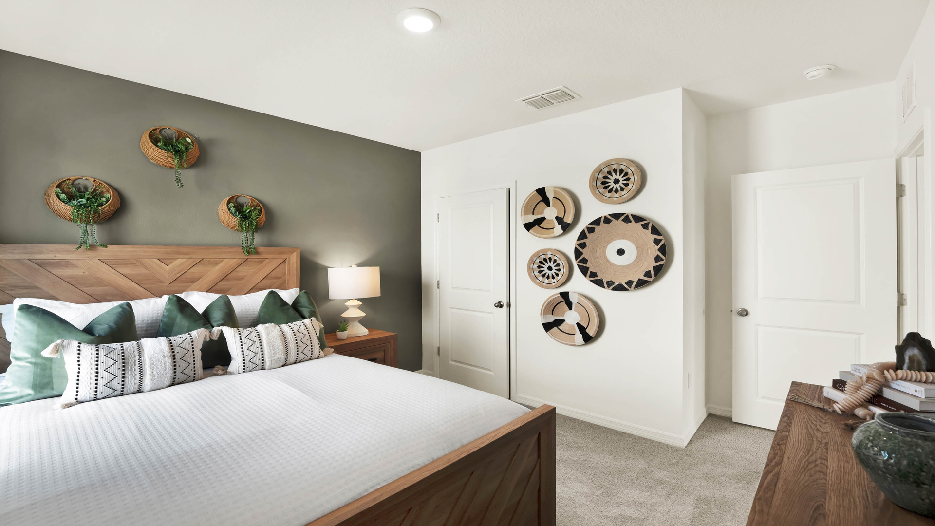 Guest bedroom with bed, nighstands and natural lighting.