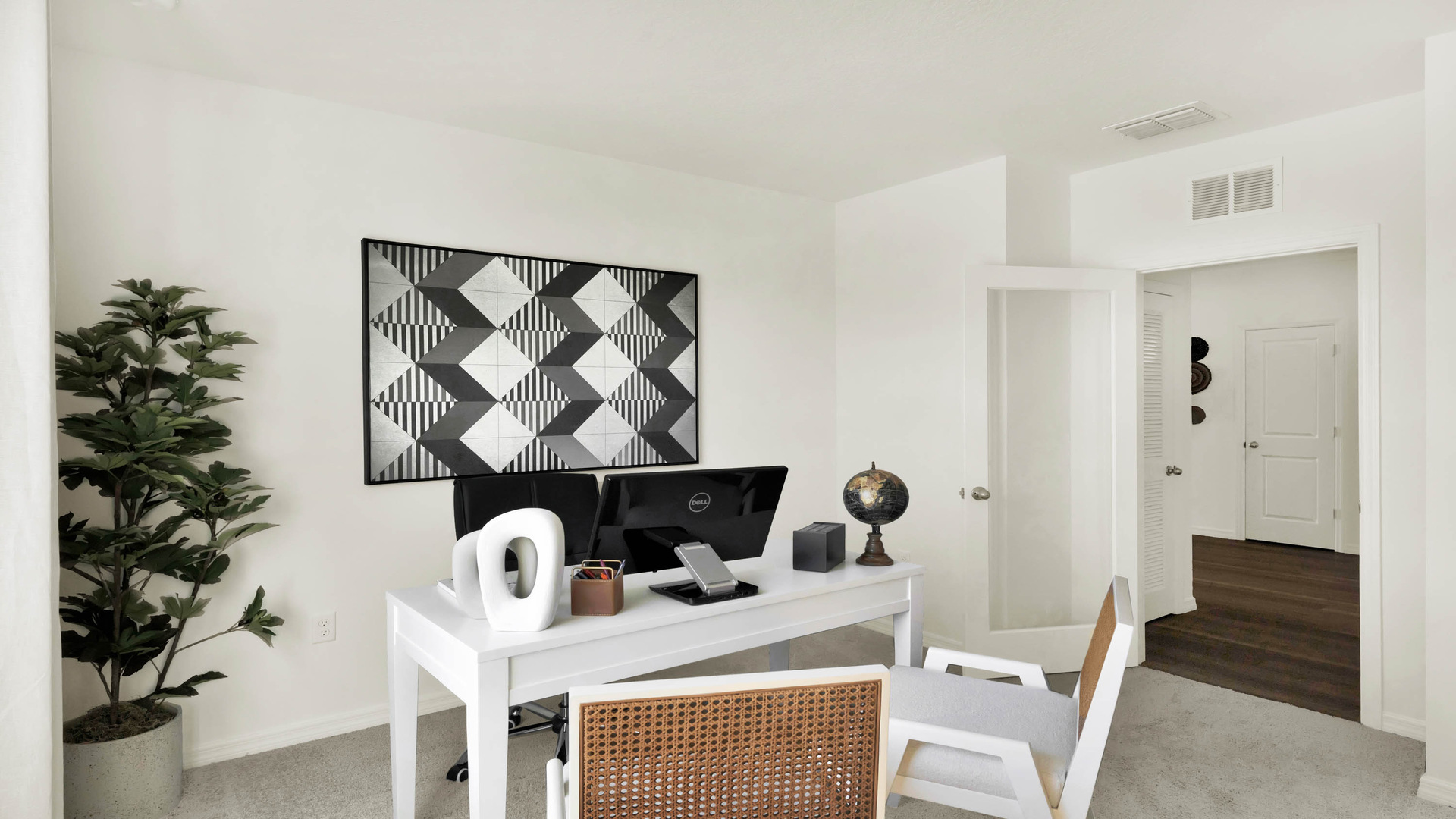 Functional home office with desk, chairs and space to work or play.