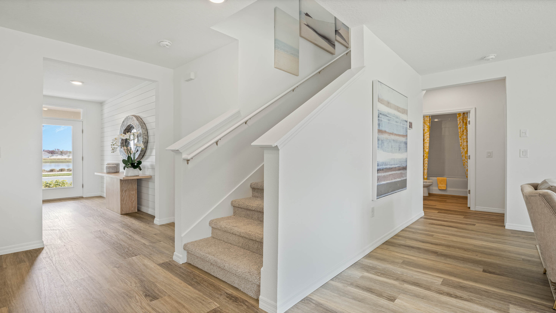 Carpeted staircase and entry way.