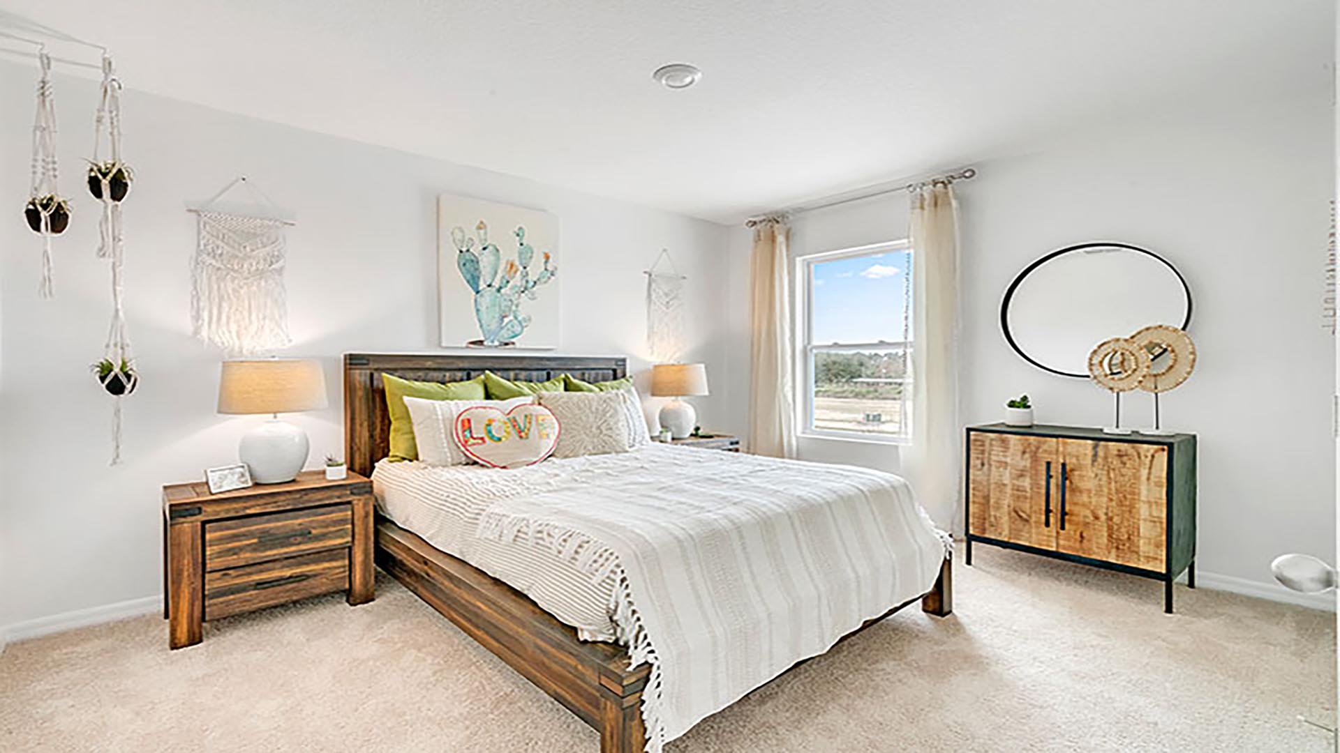 Guest bedroom with bed, nighstands and natural lighting.