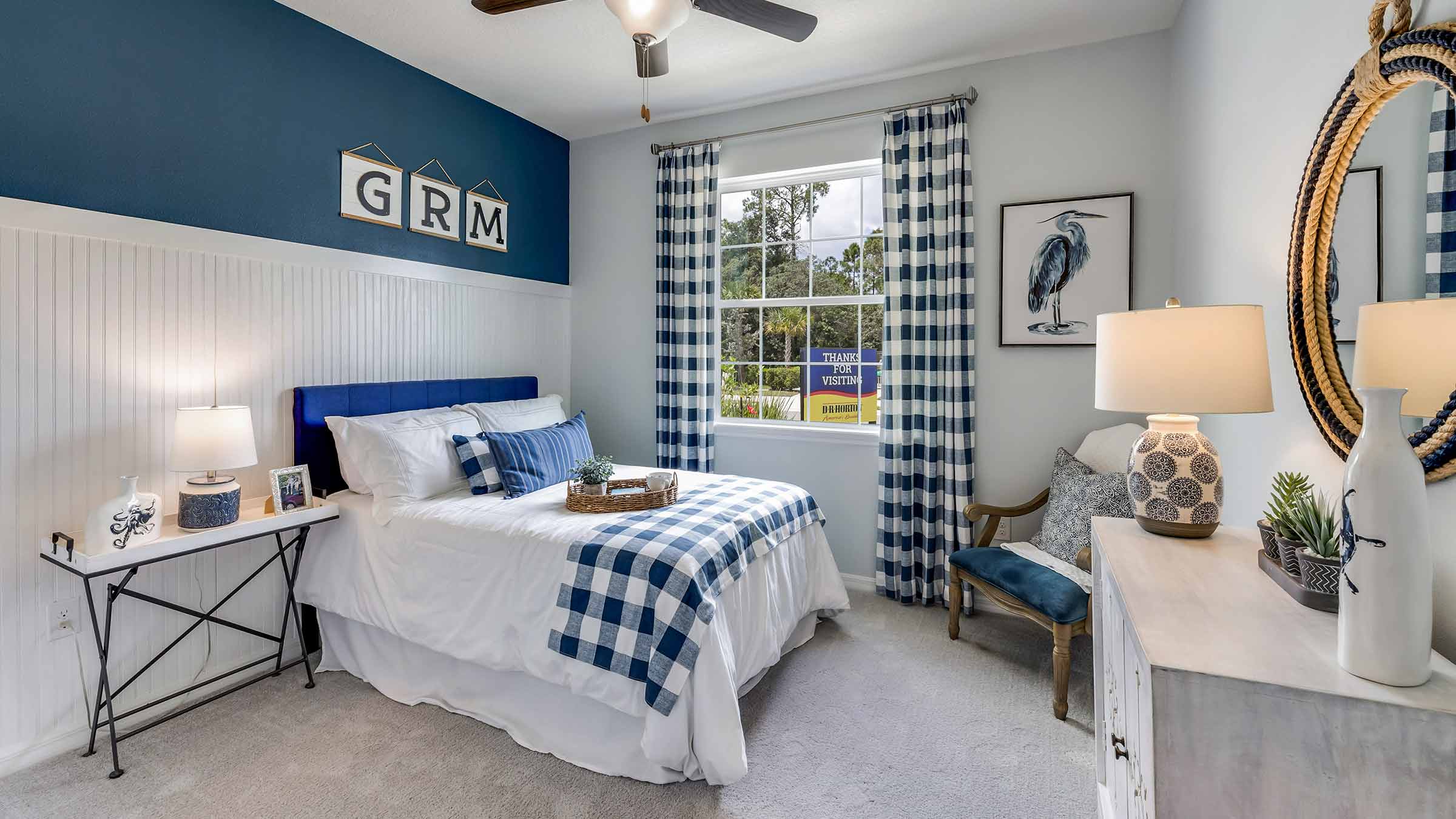 Bedroom with blue décor and ceiling fan