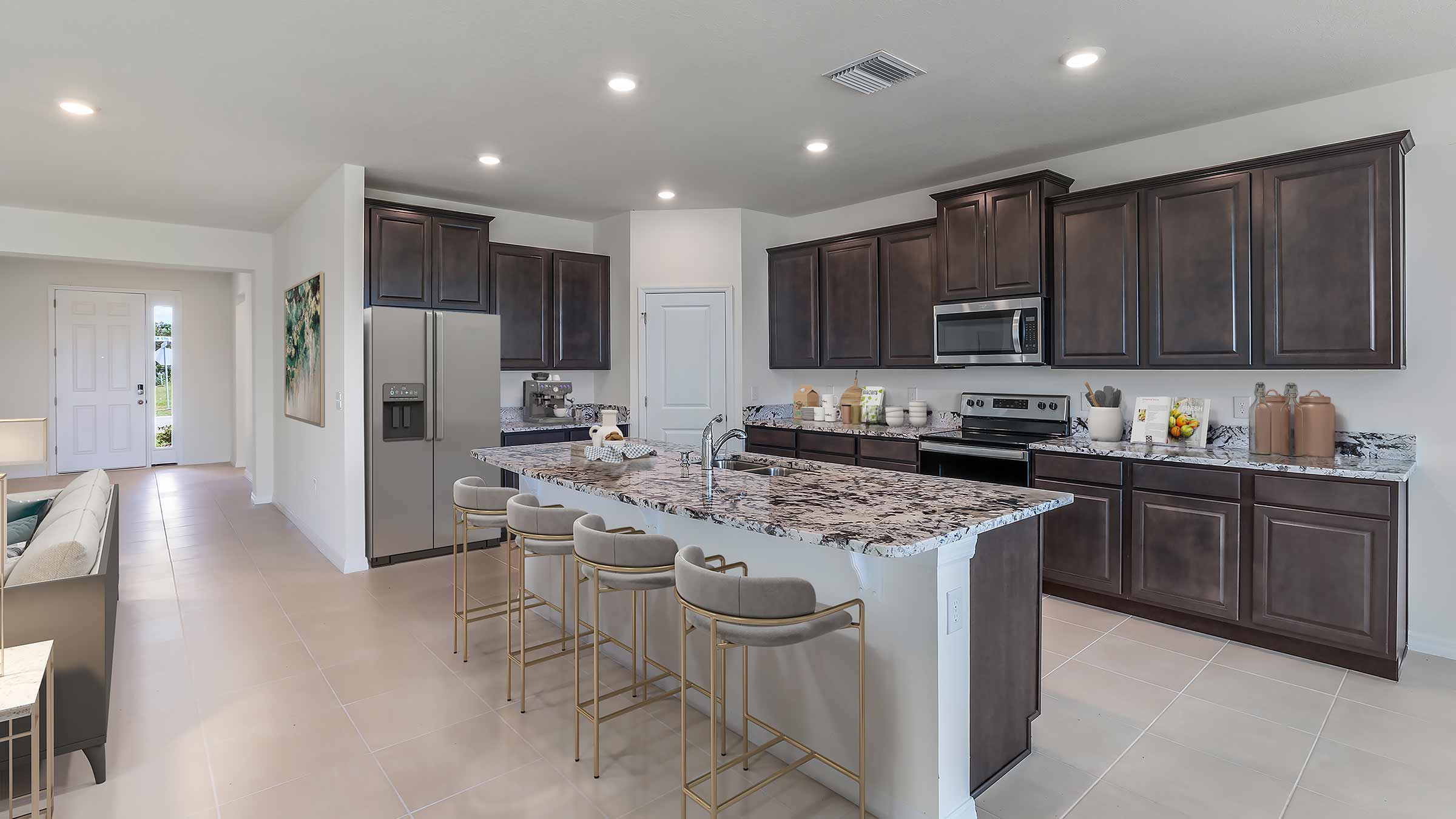 Kitchen with island and dark cabinets and stainless steel appliances
