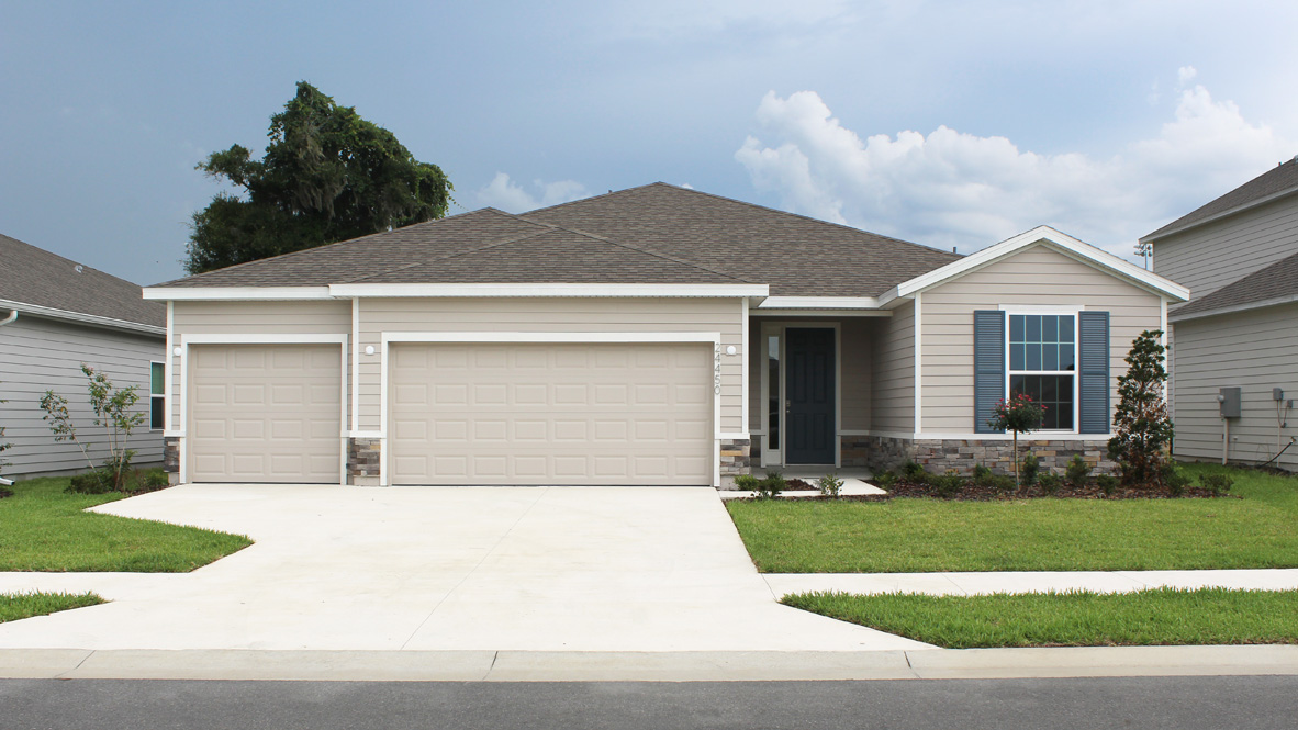 single-story exterior with light siding and front window and garage