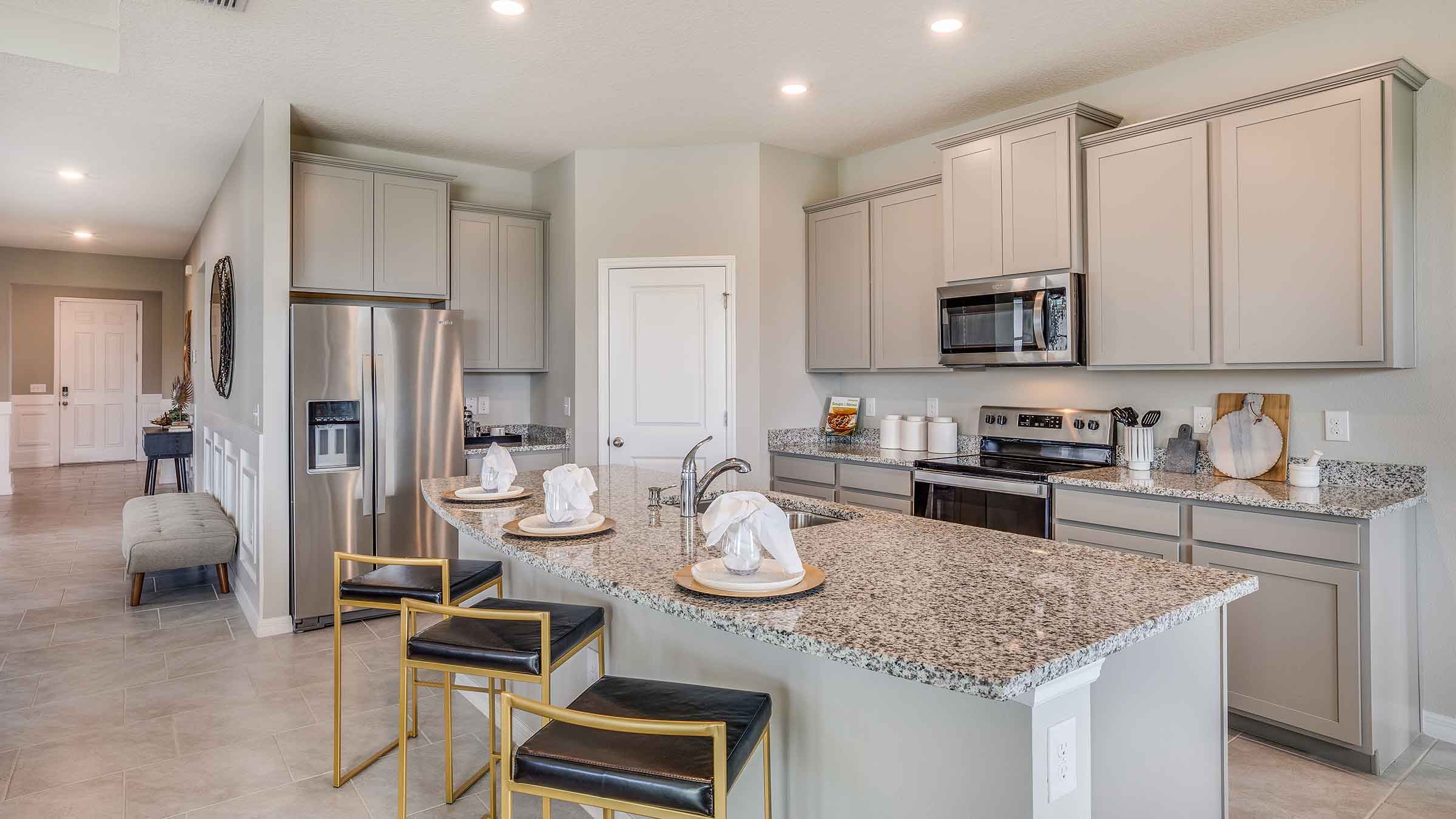 Kitchen with island and light cabinets and stainless steel appliances