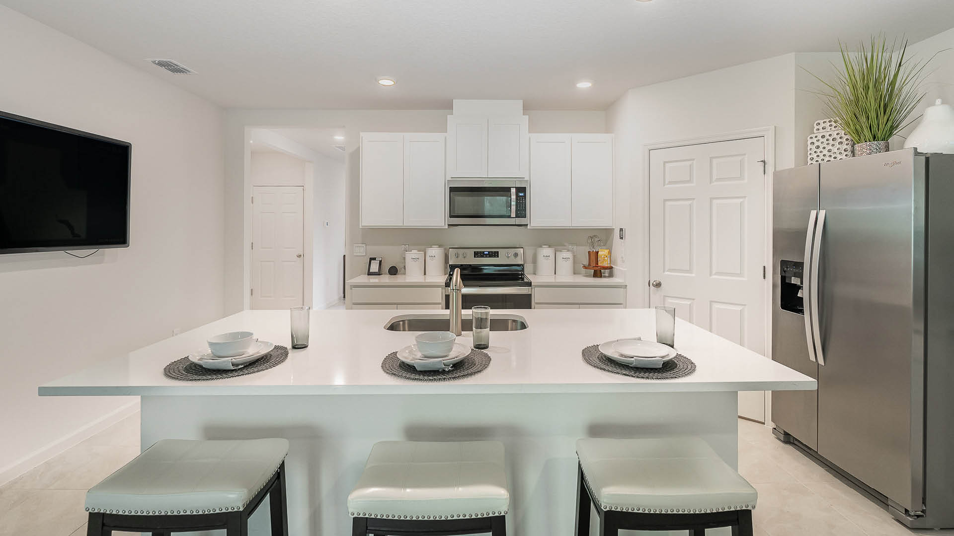 Kitchen island overlooking kitchen with white cabinets