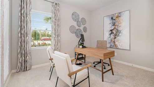 Bright and modern home office featuring a wooden desk, two chairs, decorative wall art, and a large window with curtains.
