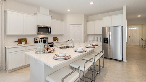 Delray Kitchen featuring white cabinets, beautiful island and stainless appliances