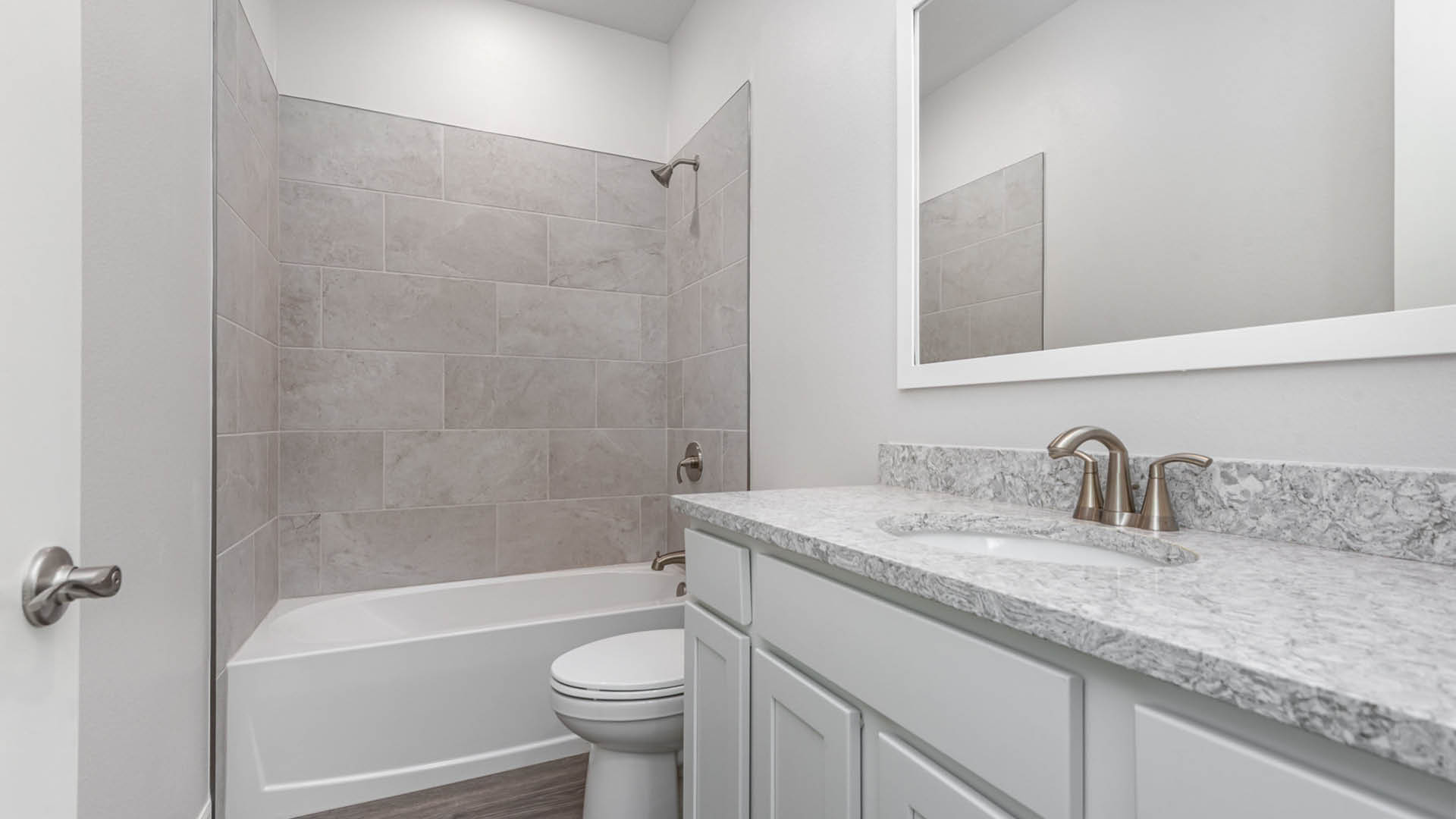 A bathroom featuring a sink, toilet, and shower, designed for everyday use and convenience.