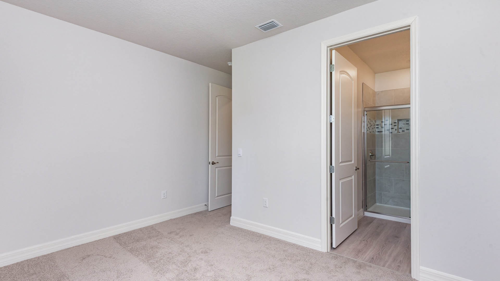 A room featuring a door and a closet, showcasing a simple interior design.