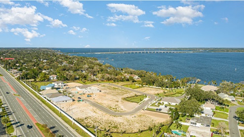 Aerial view of community showing the neighborhood, river, main crossroads and causeway..
