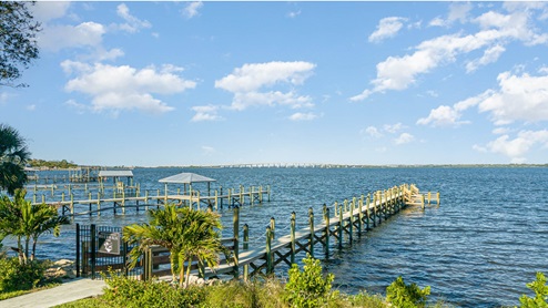 Community dock over the river with private entry gate.
