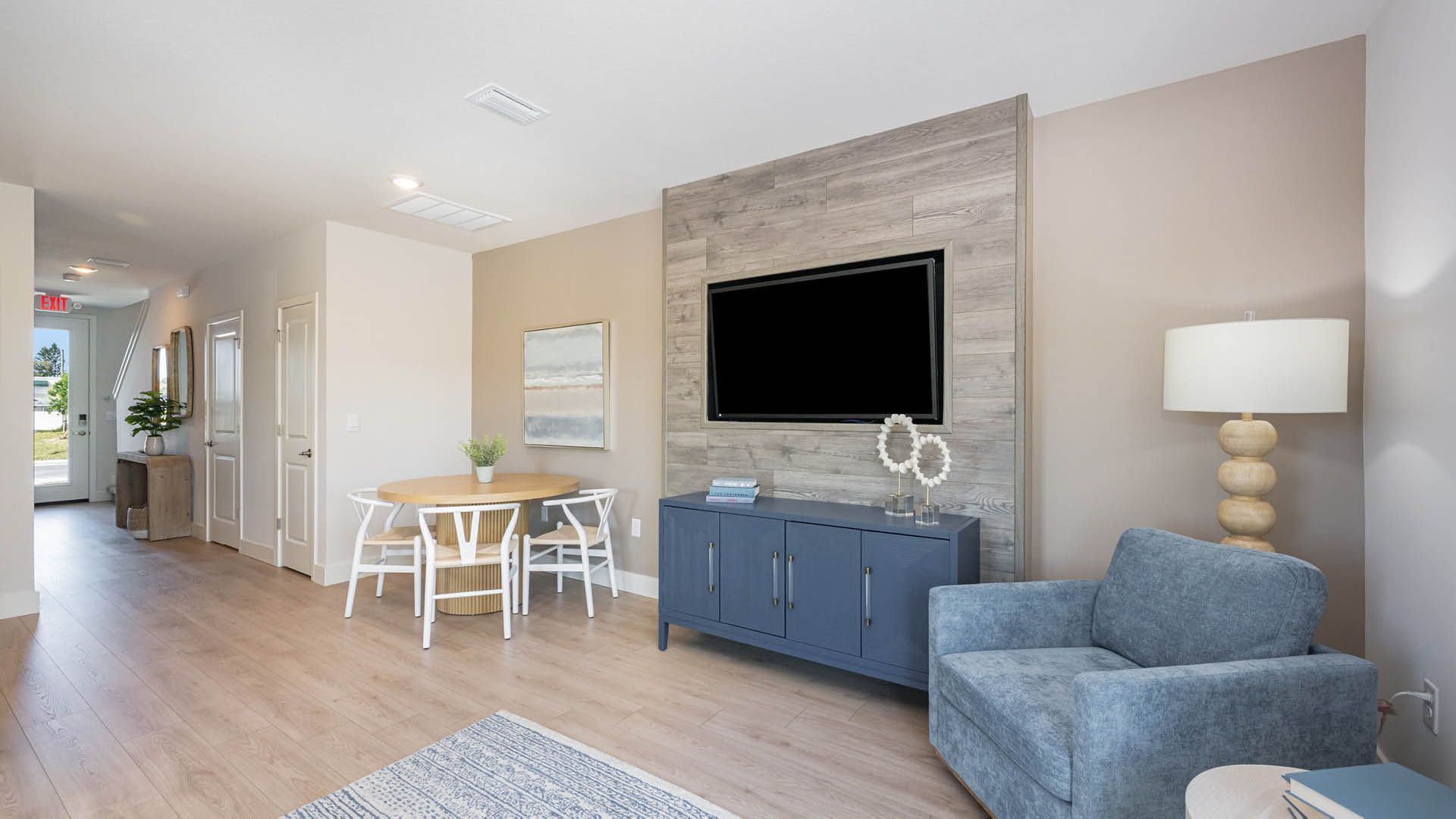 Cozy living room with blue credenza with TV mounted above.
