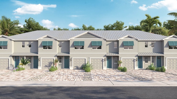 Modern townhouses with teal accents one car garages and paver driveways.