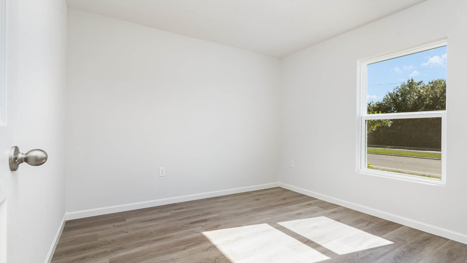 A large bedroom with a window.