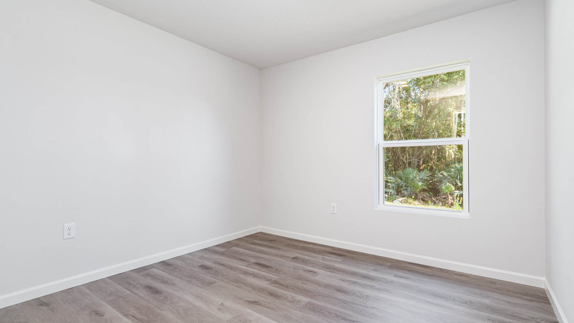 A large bedroom with a window.