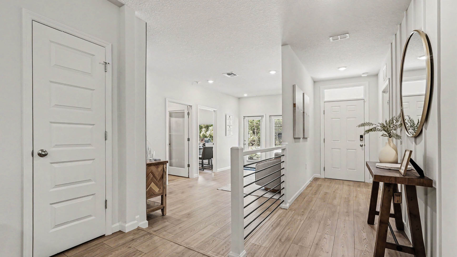 An entryway hallway leading to the front door and hall closet. A garage converted into an office space is visible.