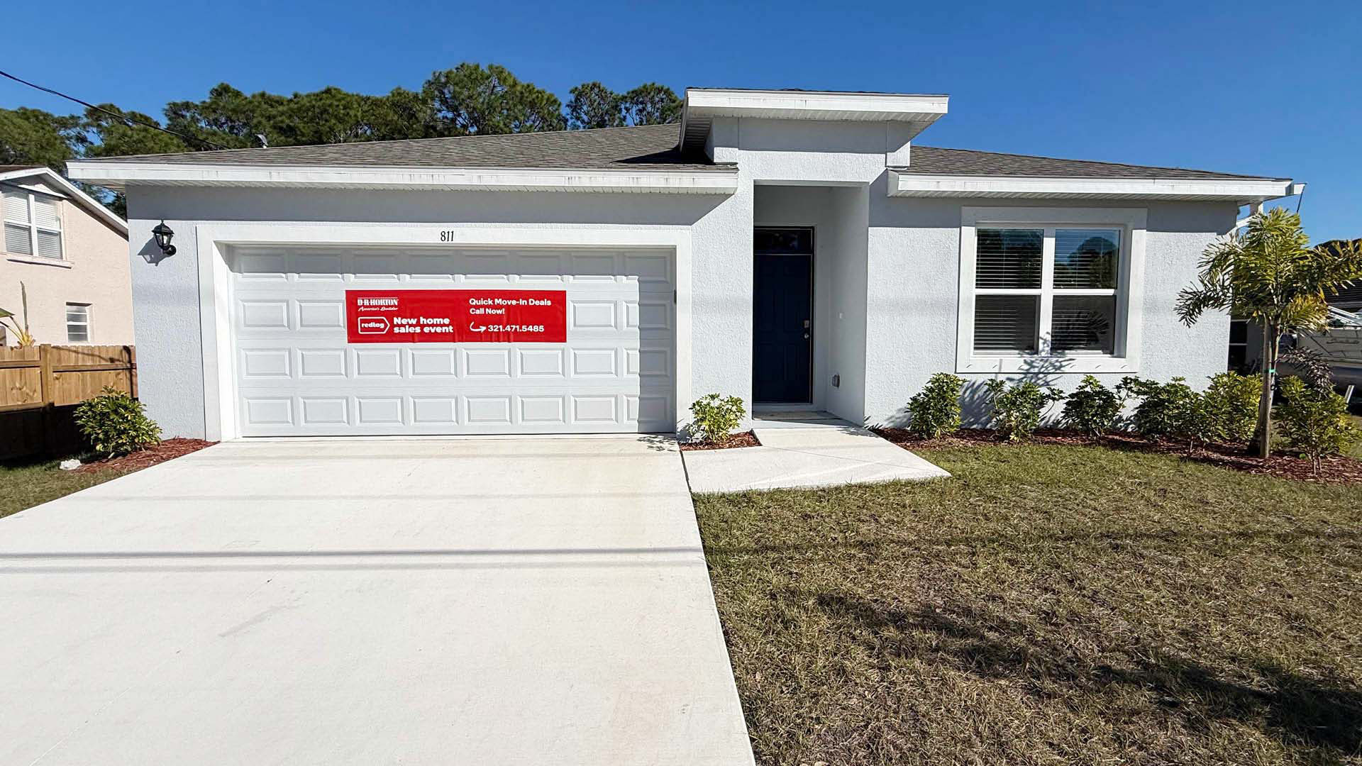 single story home with shingle roof and two car garage.