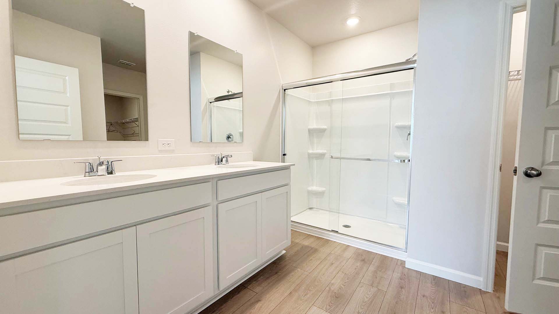 A modern bathroom featuring a walk-in shower and a sleek sink, designed for functionality and style.