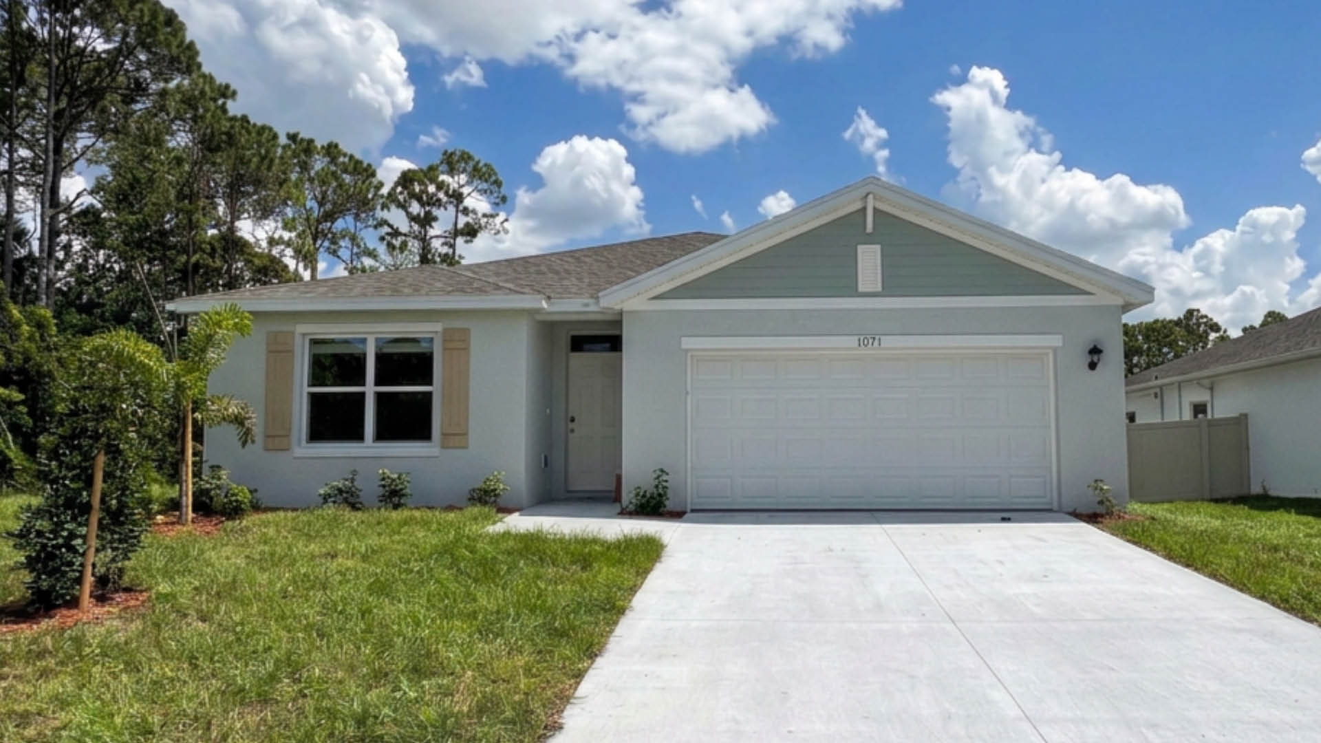 An exterior photo showing a modern single-family home with a shingled roof and manicured landscaping.