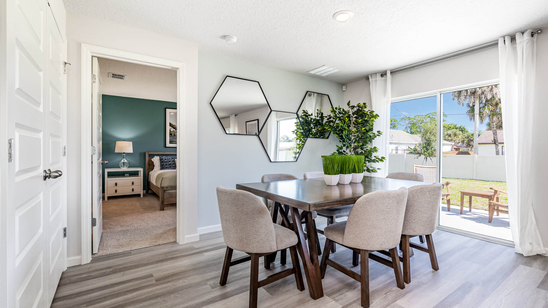 Kitchen nook area with brown wood table and beige chairs.