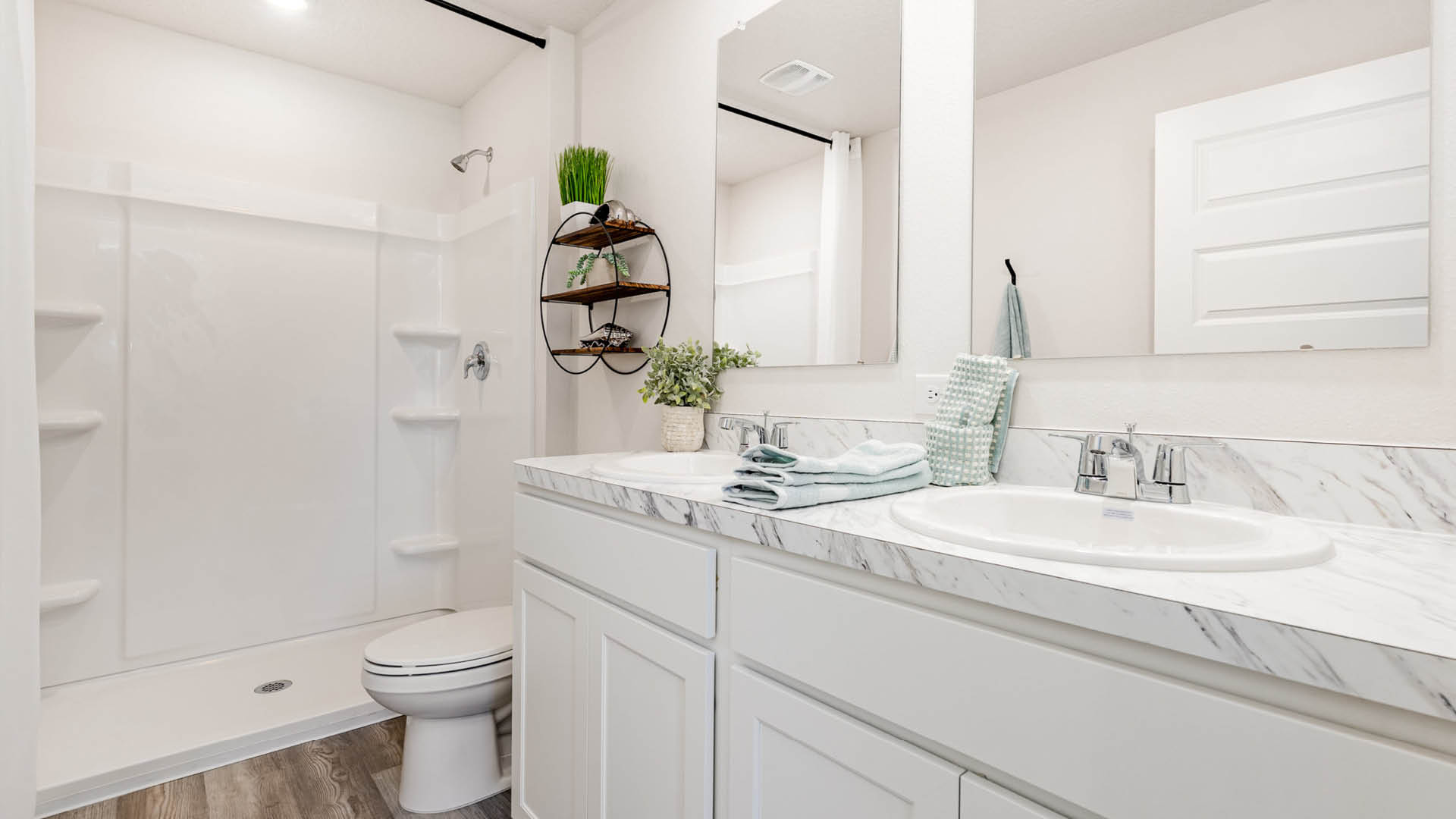 Primary bedroom, bathroom with shower and light countertops.