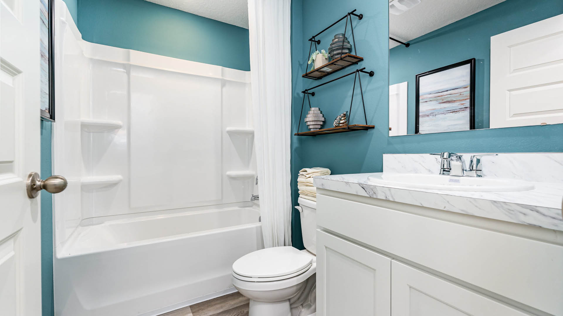 Bathroom featuring bathtub, shower and comfort height toilets.