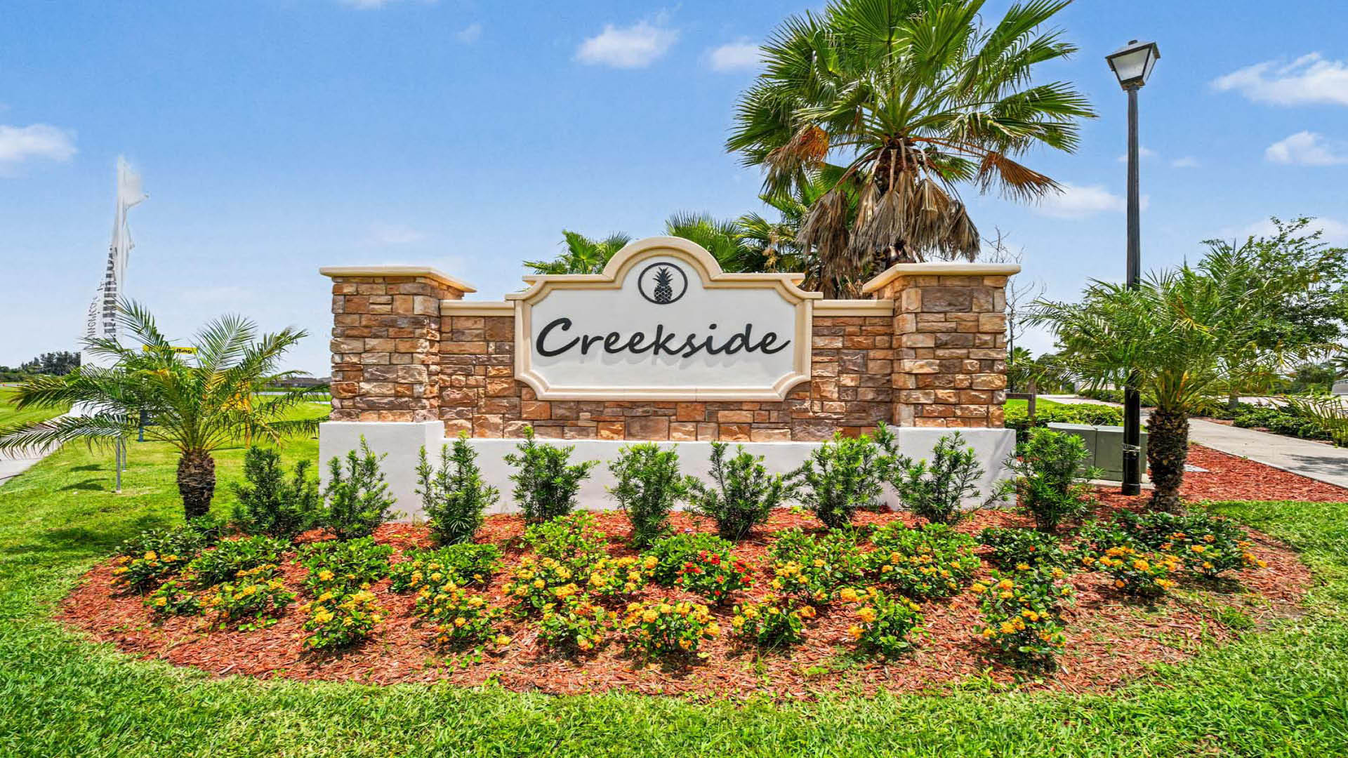 An outdoor monument sign reading "Creekside".
