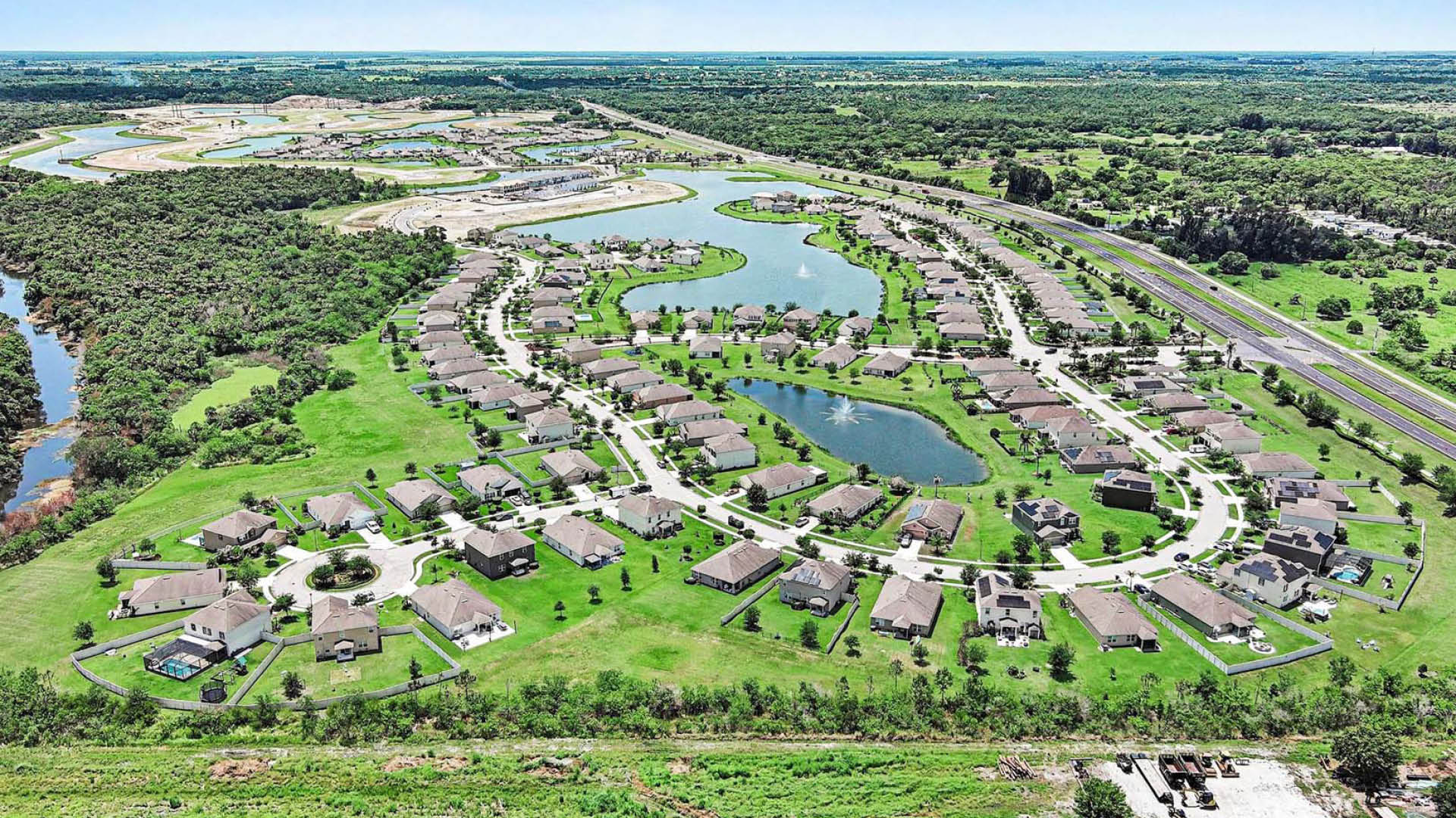 An aerial view of a well-built community with several water features throughout.