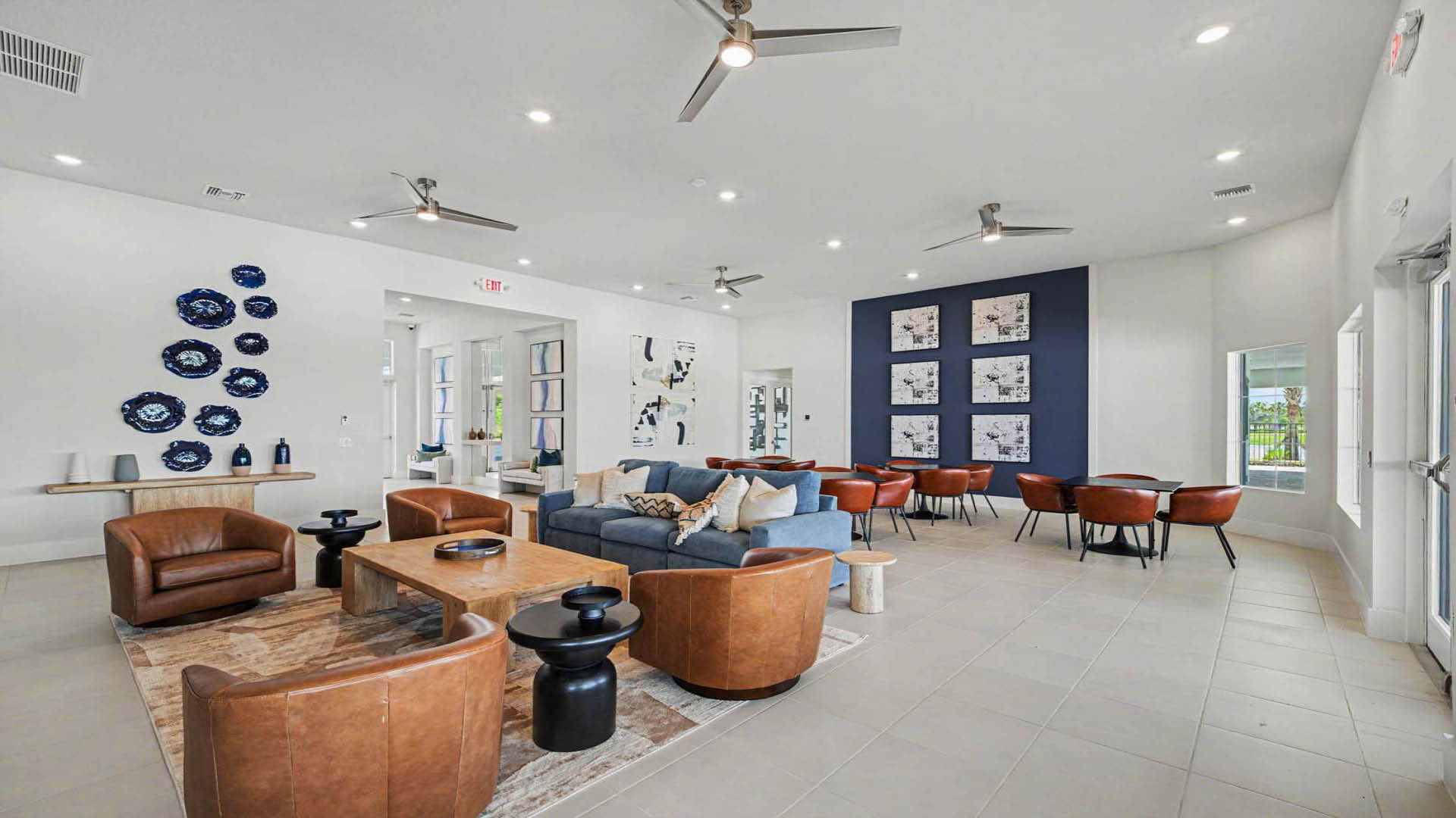 A large gathering space with tables and chairs, couches, and lounge areas.