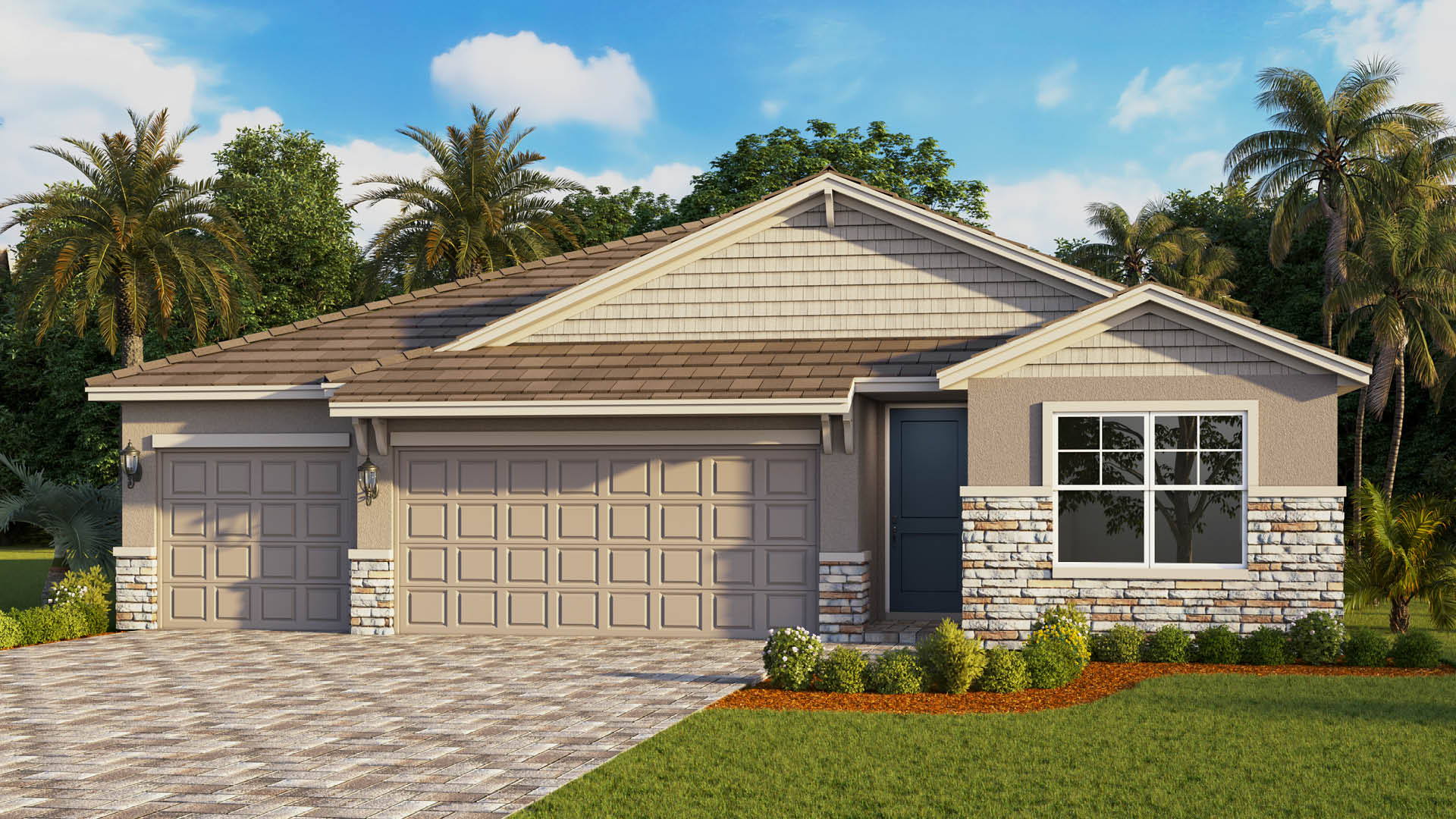 A single-story modern craftsman home features a beige exterior with stone accents, a three-car garage, a dark blue front door, and a patterned brick driveway surrounded by lush tropical landscaping under a clear blue sky.
