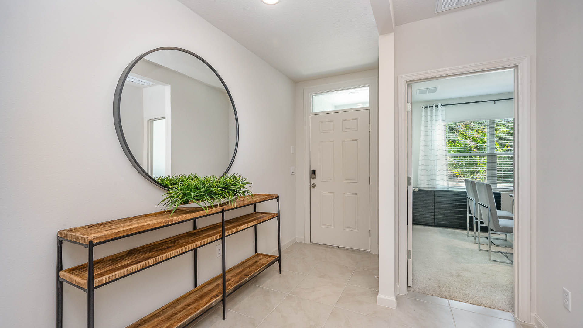 An exterior photo showing a modern single-family home with a shingled roof and manicured landscaping under a blue sky.