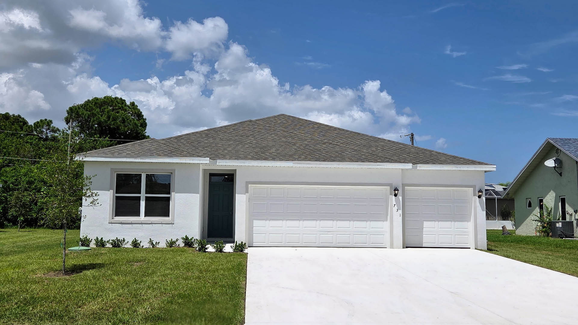 An exterior photo showing a modern single-family home with a shingled roof and manicured landscaping.