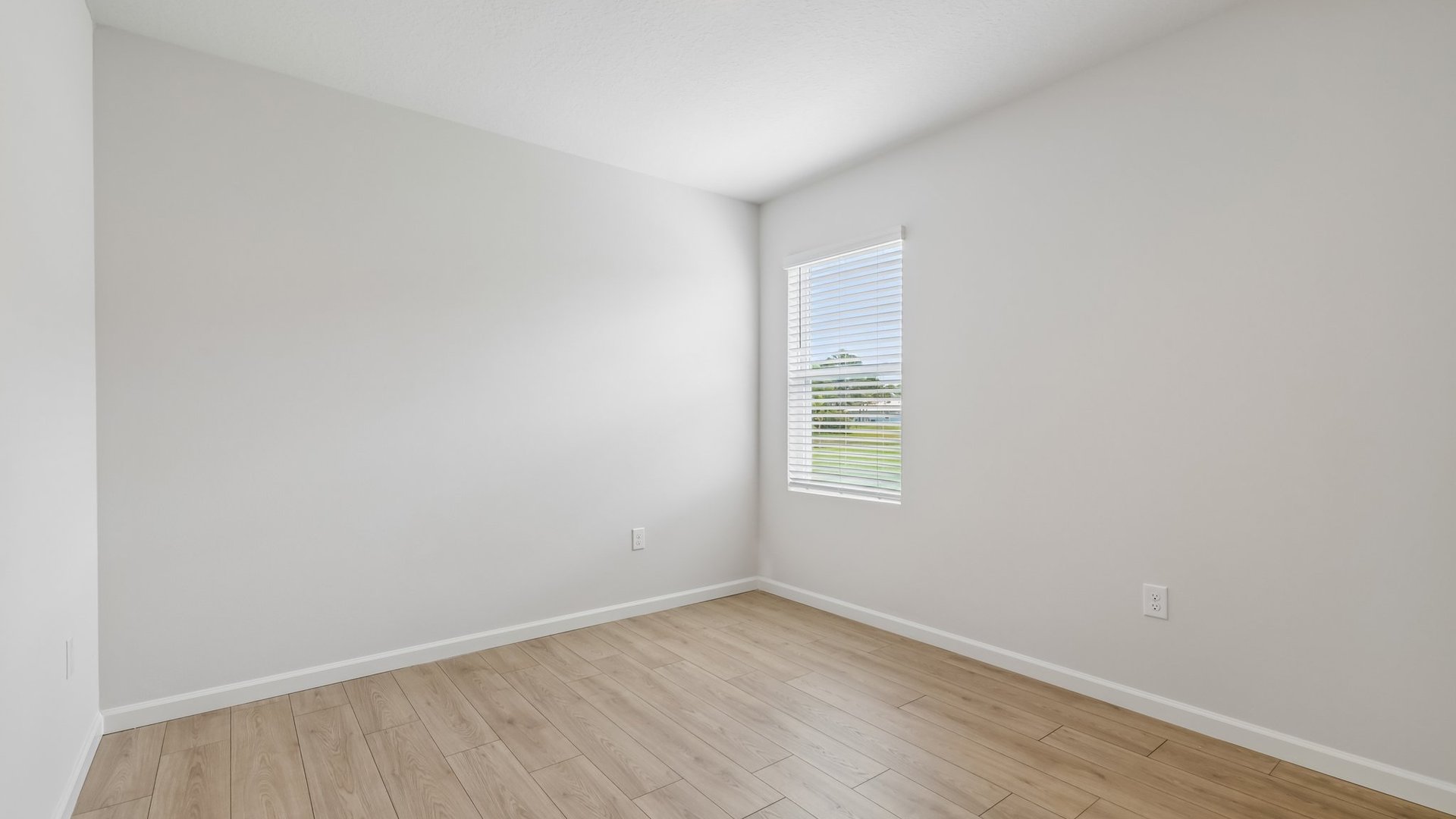 An empty room with a window, allowing natural light to illuminate the space.