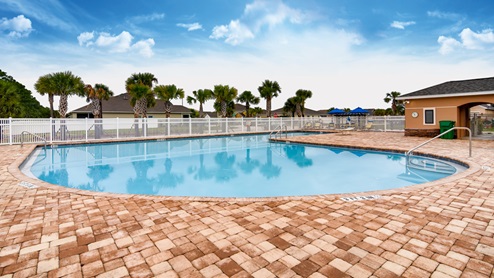 Resort-Style Pool with paver deck and bathrooms
