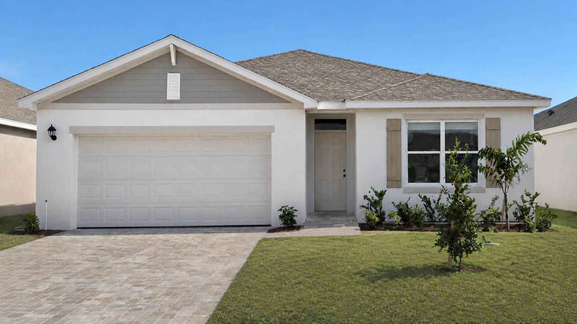 An exterior photo showing a modern single-family home with a shingled roof and manicured landscaping.