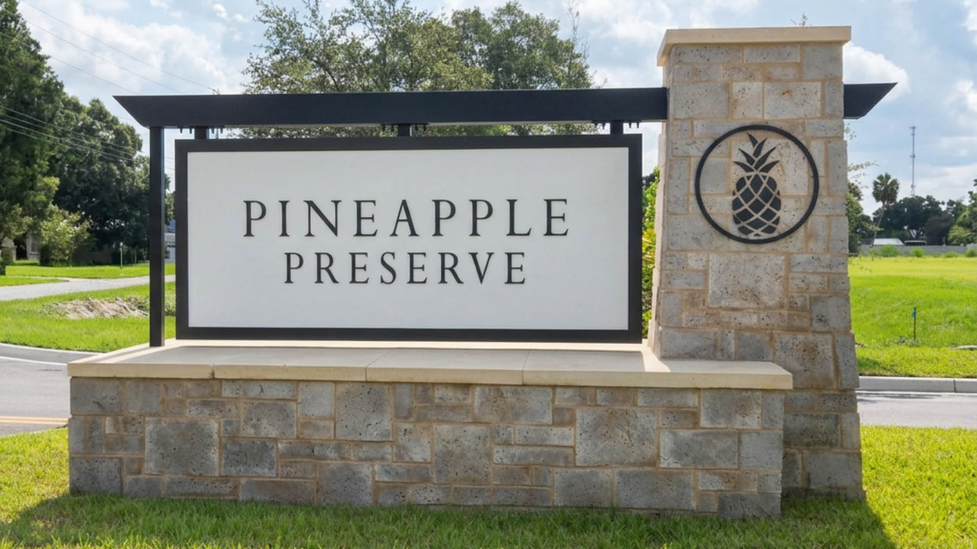 A monument sign at the entrance to a neighborhood reading "Pineapple Preserve"