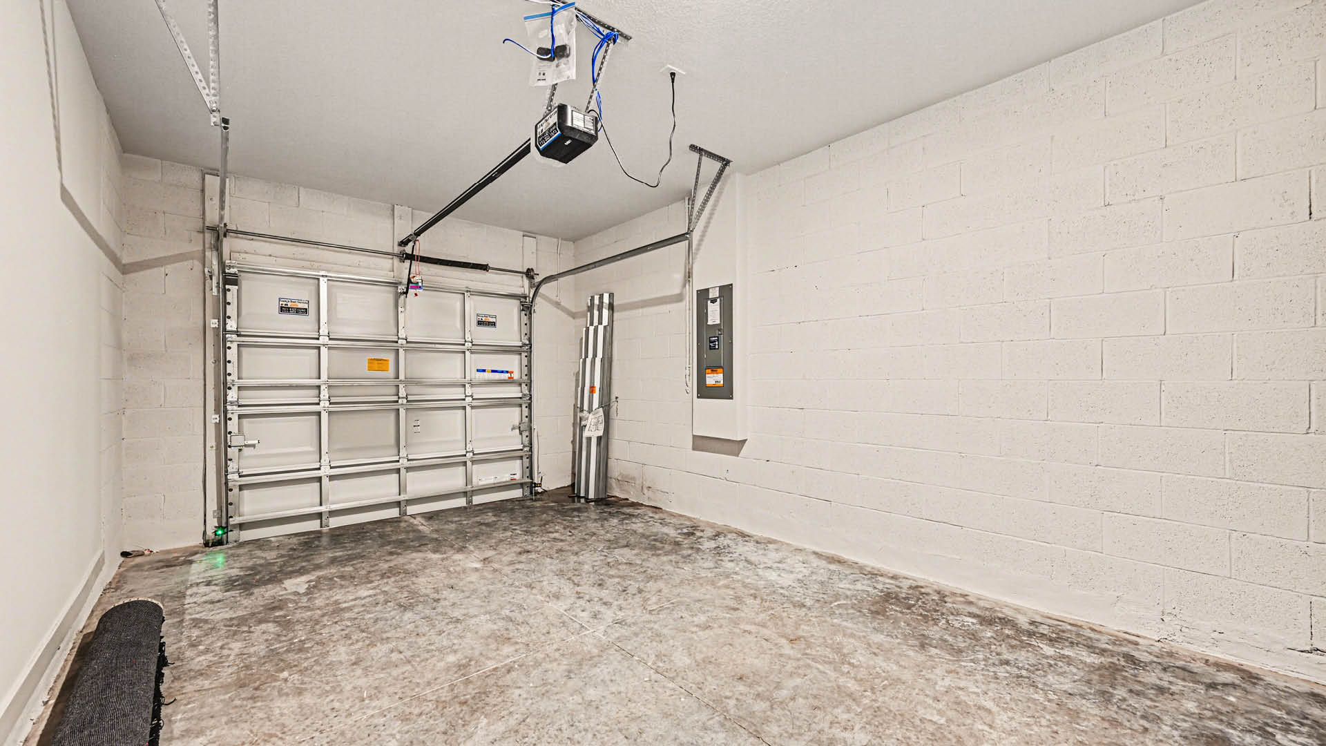 A spacious single-car garage with steel garage door.