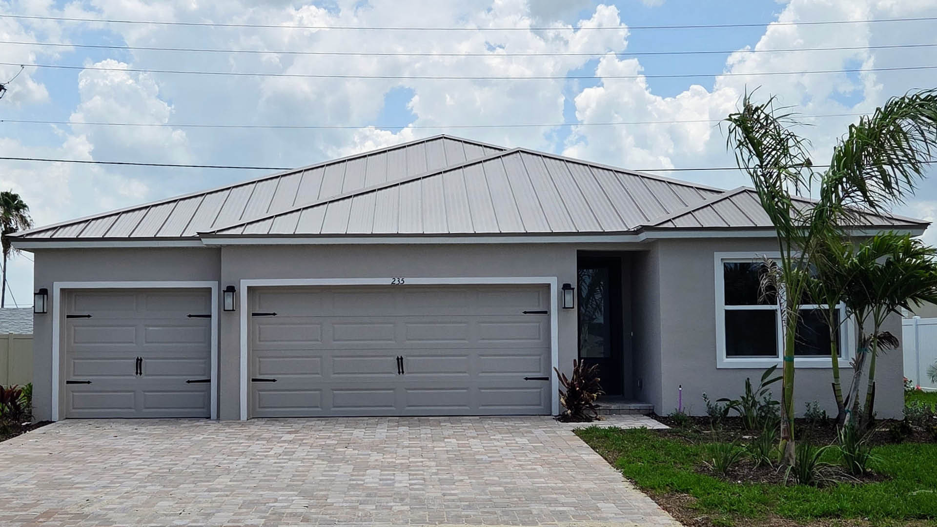 An exterior photo showing a modern single-family home with a shingled roof and manicured landscaping.
