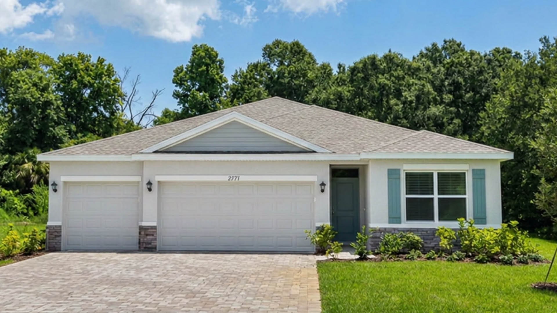 An exterior photo showing a modern single-family home with a shingled roof and manicured landscaping.