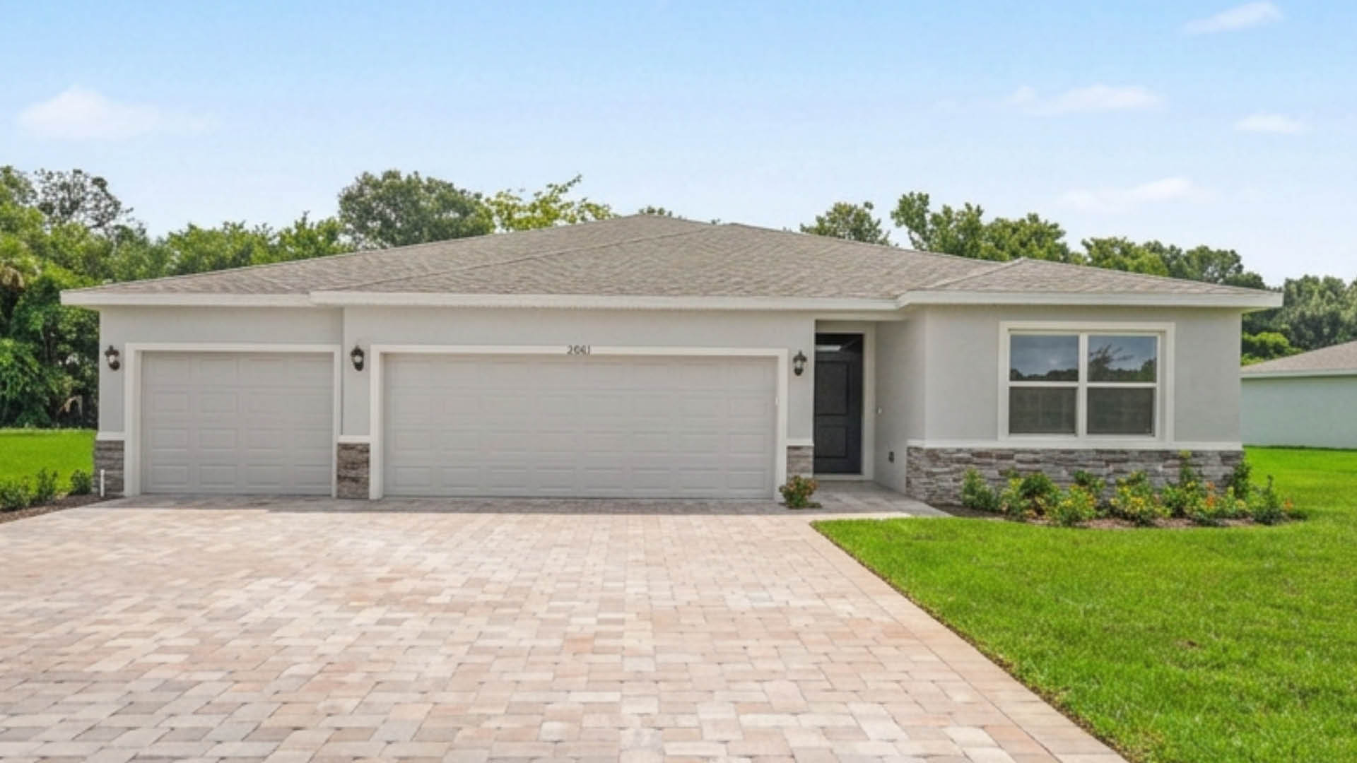 An exterior photo showing a modern single-family home with a shingled roof and manicured landscaping.