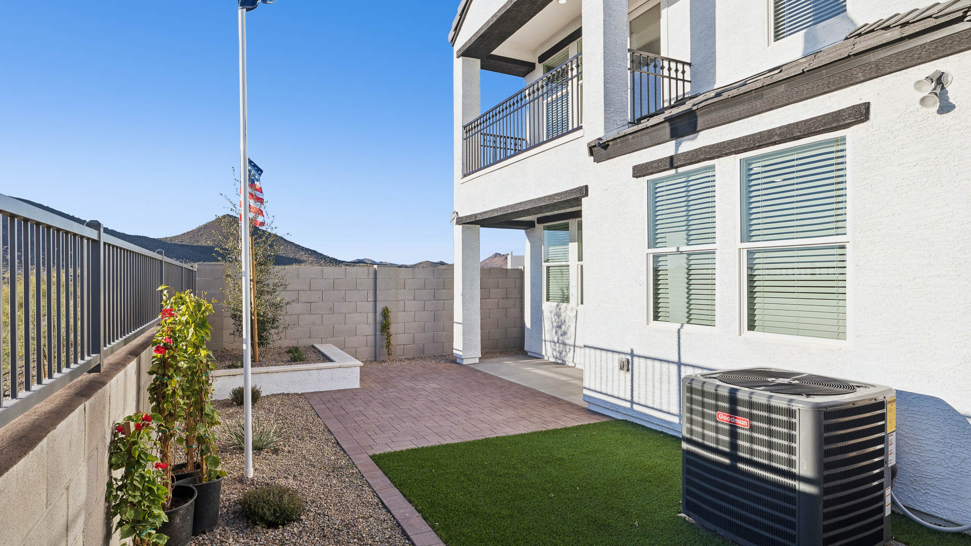 Backyard with covered concrete patio offering grill setup and outdoor living space