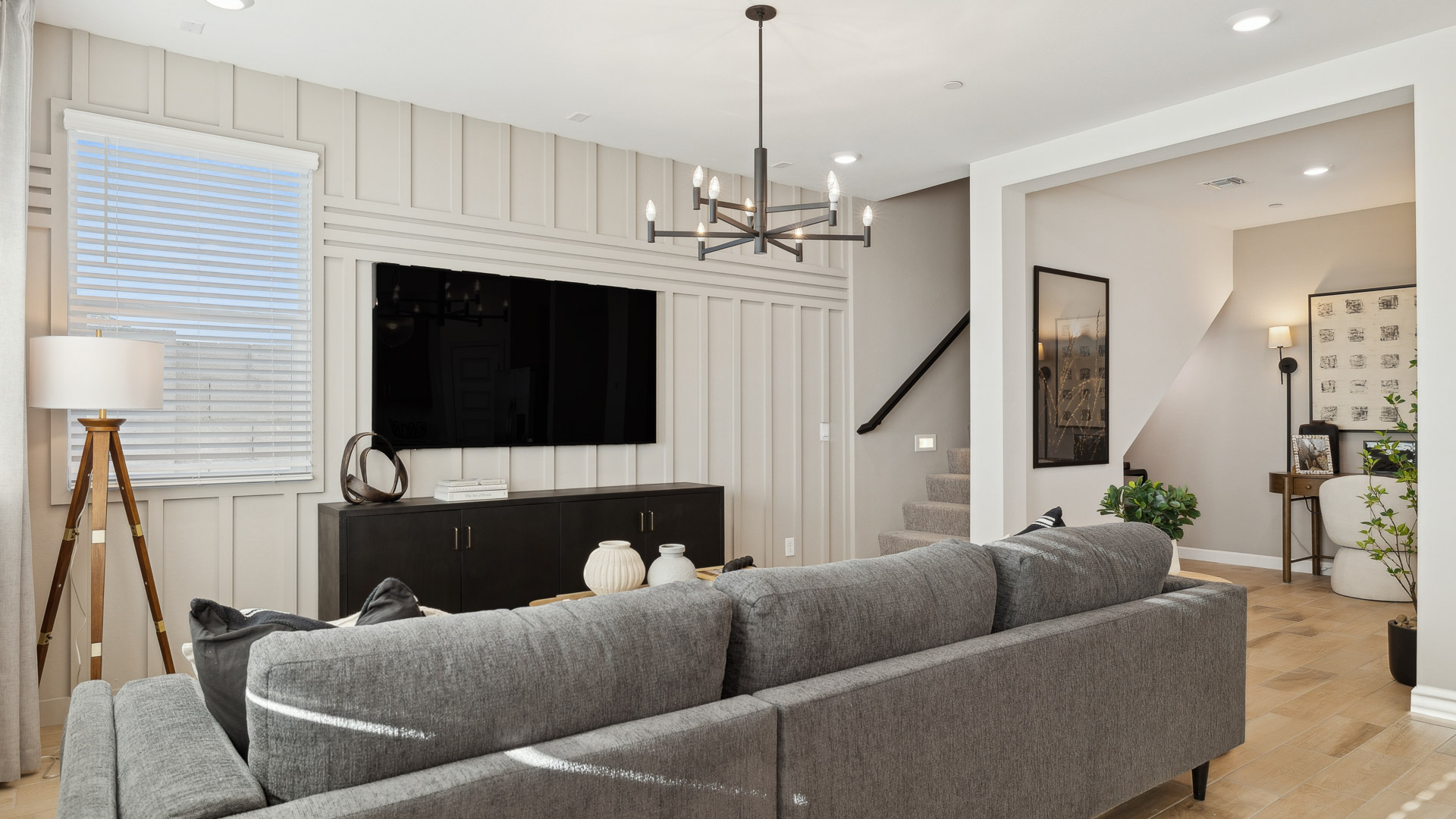 Main living room with open concept flow and direct stair access to upstairs loft and bedrooms