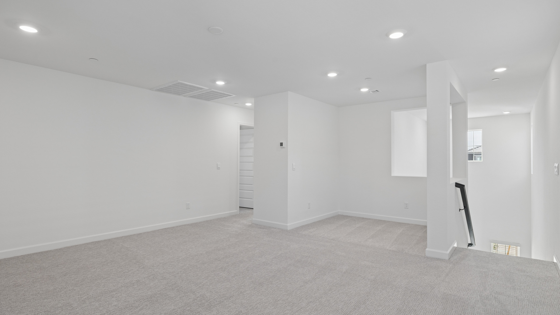 Upstairs play and seating area near large windows and the additional bedrooms.
