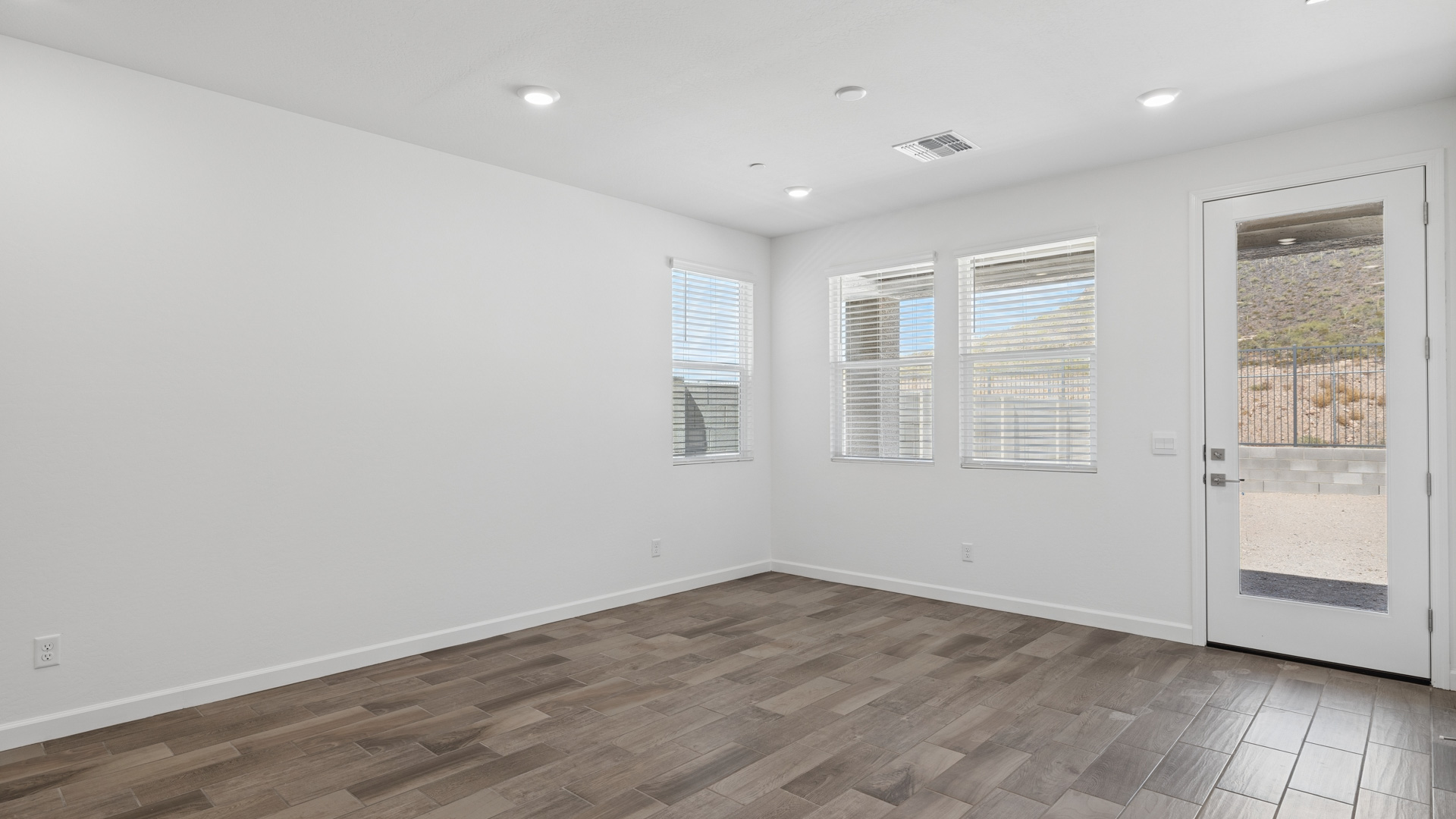 A well-organized living room that includes a kitchen and dining area, creating a warm and welcoming environment for gatherings.