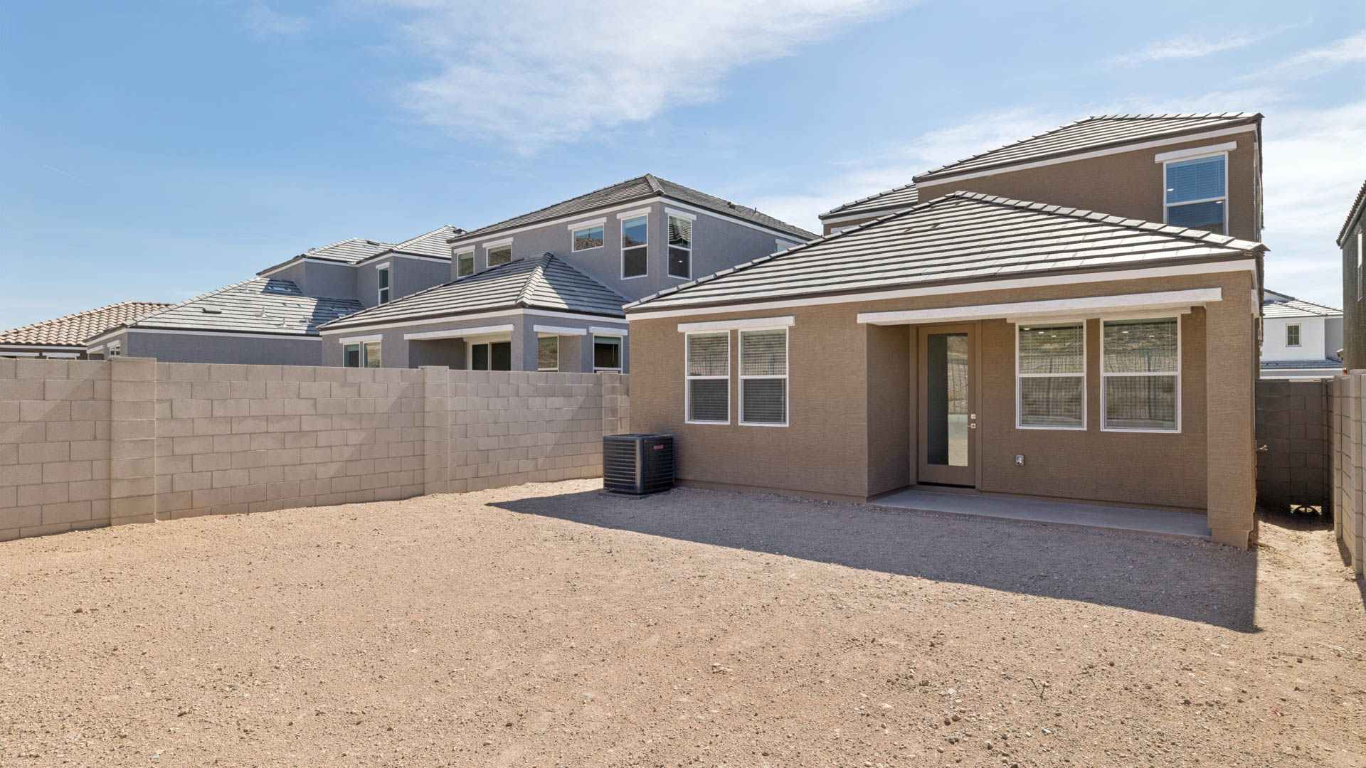 Large fenced-in backyard with a covered patio, perfect for outdoor entertaining.