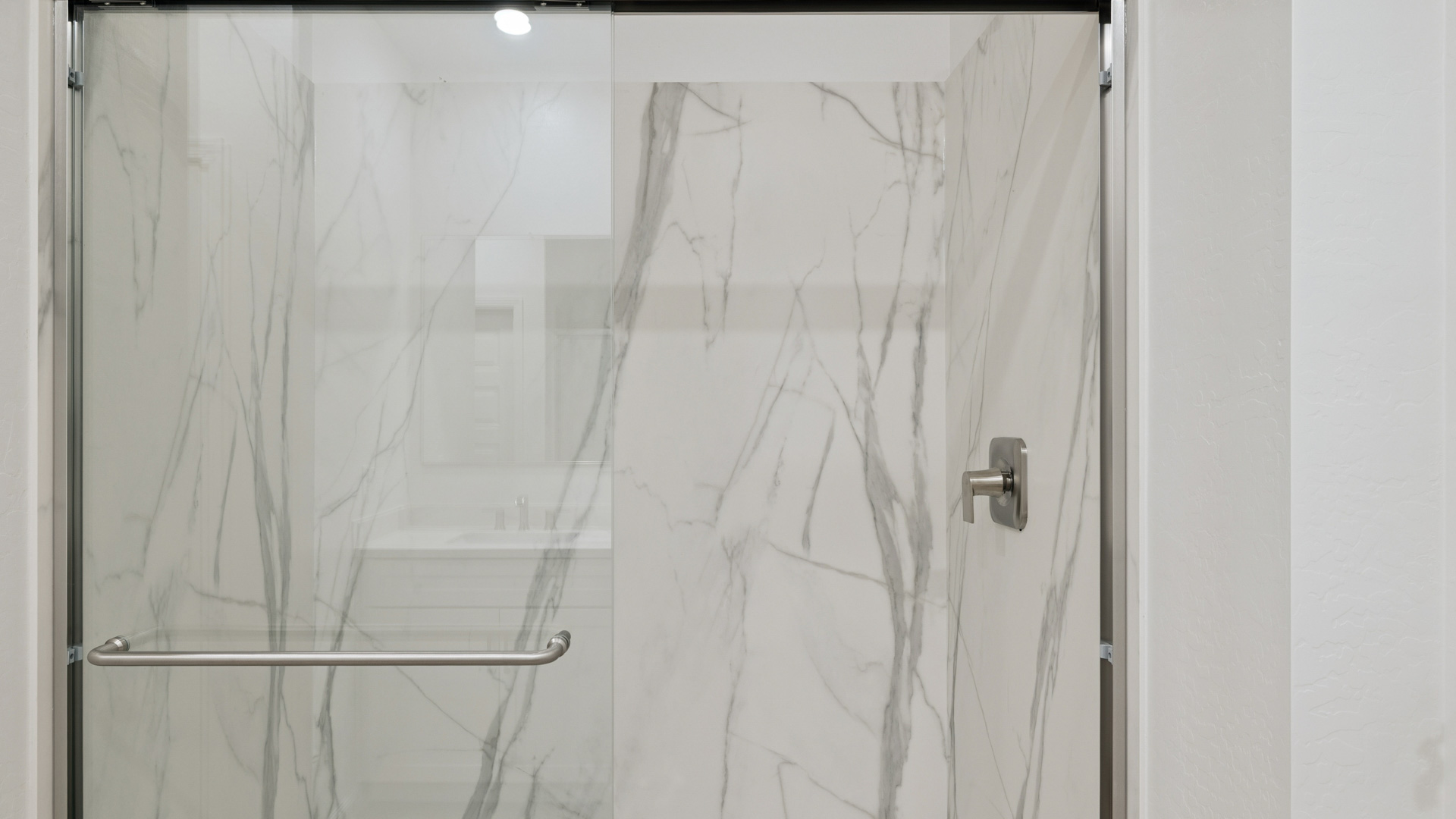 Primary bathroom with dual vanities.
